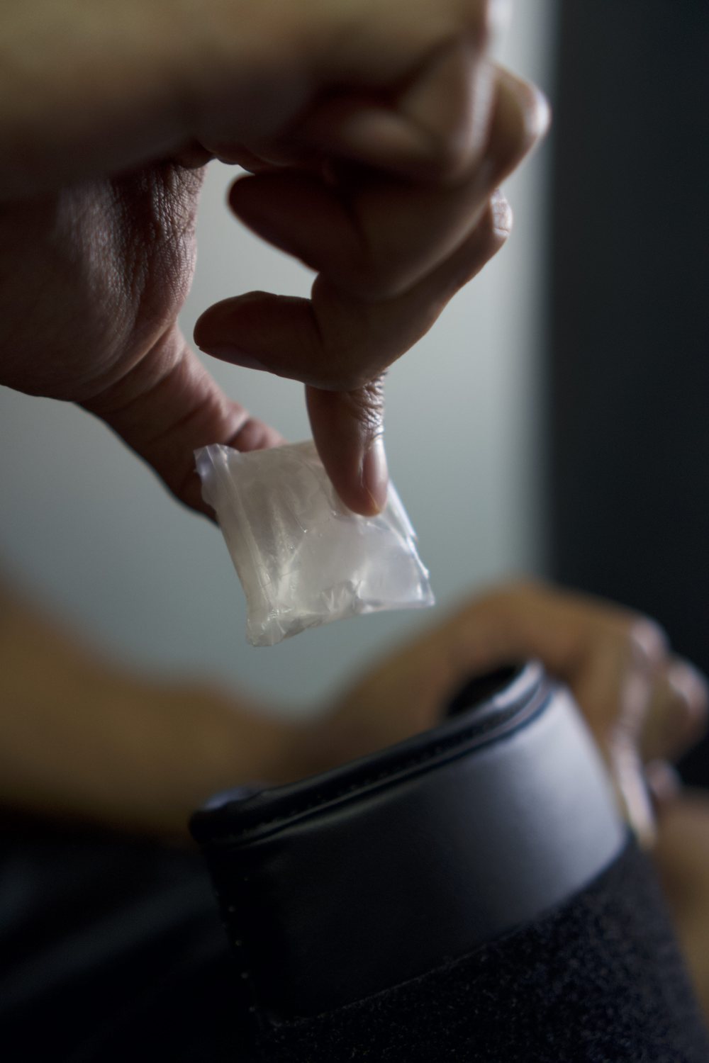 Sachet held above an open glove